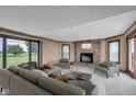 Spacious living room with a cozy fireplace and large windows offering a view of the outdoors at 4545 W 200 S, Lebanon, IN 46052
