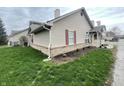 Exterior view of a charming townhouse with well-maintained lawn and vinyl siding at 4767 Kelvington Dr, Indianapolis, IN 46254