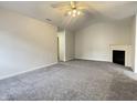 Bright living room with vaulted ceiling, fireplace, and neutral carpet at 4767 Kelvington Dr, Indianapolis, IN 46254