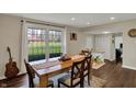 Bright dining room featuring a wooden table, large windows and wood floors at 5311 Larita Ln, Anderson, IN 46017