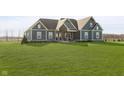 Beautiful home exterior with green siding and a well-kept lawn, perfect for a Gathering or entertaining at 5679 S 675 W, New Palestine, IN 46163