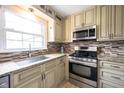 Bright kitchen features granite countertops, mosaic backsplash, stainless steel appliances, and ample cabinetry at 5735 Brouse Ave, Indianapolis, IN 46220