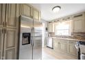 Bright kitchen features granite countertops, stainless steel appliances, ample cabinetry, and a light-filled window at 5735 Brouse Ave, Indianapolis, IN 46220
