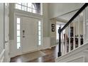 Inviting foyer with hardwood floors, staircase, and natural light from the large window above the front door at 6037 Porter Ln, Noblesville, IN 46062