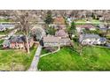 Aerial view of a home surrounded by mature trees and well-maintained lawns at 6377 Green Leaves Rd, Indianapolis, IN 46220