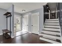 Inviting entryway with dark wood floors, fresh paint, and staircase with runner at 6377 Green Leaves Rd, Indianapolis, IN 46220