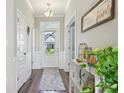 Bright foyer with wood flooring, a view through the front door, and decorative accents at 6557 Eagles Nest Ln, McCordsville, IN 46055