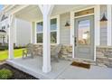 Inviting covered front porch with seating area, providing a cozy outdoor space and stylish entryway at 6557 Eagles Nest Ln, McCordsville, IN 46055