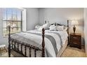Cozy bedroom with a wood-frame bed, soft bedding, and a sunny window at 760 Sable Ridge Dr, Greenwood, IN 46142