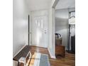 Inviting entryway featuring hardwood floors, a bench, and a view into the living area at 8017 Wallingwood Dr, Indianapolis, IN 46256