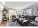 Comfortable living room showcasing a large sectional sofa, hardwood floors, and ample natural light at 8017 Wallingwood Dr, Indianapolis, IN 46256