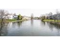 Expansive lake view showcasing tranquil water surrounded by residential properties in a peaceful neighborhood setting at 8075 N Cardinal W Cv, Indianapolis, IN 46256