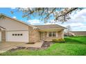 Well-maintained single-story home with two car garage and blossoming tree at 8242 Frankdale Ct, Indianapolis, IN 46259