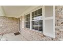 Inviting front porch of a brick home with white-framed windows at 8242 Frankdale Ct, Indianapolis, IN 46259