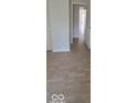 Hallway showing hardwood floors and light walls, creating a seamless flow between rooms at 8277 Sobax Dr, Indianapolis, IN 46268