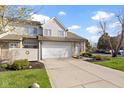 Inviting townhome with an attached garage, landscaped yard, and neutral exterior at 9442 Avon Strand # D, Avon, IN 46123