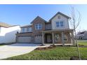 Beautiful two-story home with three-car garage, a welcoming covered entrance, and well-maintained landscaping at 10543 Banyan Wood Ct, Indianapolis, IN 46239