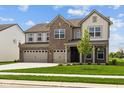 Two-story home with a three-car garage, brick facade and a neatly maintained lawn at 10543 Banyan Wood Ct, Indianapolis, IN 46239