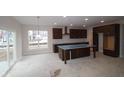 Kitchen area with modern cabinets, stainless appliances, island, and a bright window at 10543 Banyan Wood Ct, Indianapolis, IN 46239