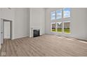 Bright living room boasts large windows, fireplace, and hardwood floors at 10543 Banyan Wood Ct, Indianapolis, IN 46239