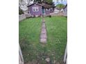 Spacious backyard with well-maintained grass and a charming concrete path at 213 S Brittain Ave, Muncie, IN 47303
