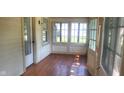 Bright sunroom features hardwood floors, white walls, and plenty of natural light at 213 S Brittain Ave, Muncie, IN 47303