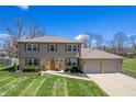 Beautiful home with brick accents, manicured lawn and two car garage at 2328 Discovery Dr, Anderson, IN 46017