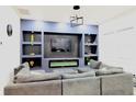 Modern living room boasts a sleek entertainment center with fireplace and comfortable seating at 249 E Minnesota St, Indianapolis, IN 46225