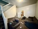 Bright living area with stairway access and good natural light from windows at 26 N Holmes Ave, Indianapolis, IN 46222