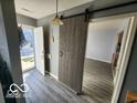 Welcoming entryway with sliding barn door and ample natural light at 2706 Country Estates Dr, Indianapolis, IN 46227