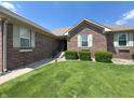 Inviting brick home with a well-maintained lawn, green shrubbery, and a welcoming front entrance with a small porch at 300 Kathryn Ct, Clayton, IN 46118