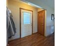 Inviting hallway with a white paneled front door, wood trim, and a neutral wall color at 300 Kathryn Ct, Clayton, IN 46118