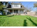 Charming two-story home with a well-maintained front yard and inviting front porch at 3438 Olive St, Indianapolis, IN 46227