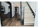 Inviting hallway features hardwood floors and staircase leading to the upper level at 3438 Olive St, Indianapolis, IN 46227