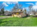 Beautifully landscaped lawn and exterior home view featuring a classic-style front porch at 3484 Birchwood Ave, Indianapolis, IN 46205