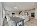 Open floor plan showcasing a dining table, kitchen island, and a cozy living room at 3799 Hoosier Down Dr, Bargersville, IN 46106