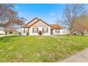 Charming home featuring a well-manicured front yard with blooming flowers and mature trees, inviting and picturesque at 448 Yorktown Ln, Avon, IN 46123