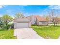 Spacious two-car garage with a driveway, set against a backdrop of a well-manicured lawn at 448 Yorktown Ln, Avon, IN 46123