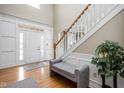 Bright foyer with high ceilings, hardwood floors, staircase, and decorative molding at 4777 Madras Ct, Zionsville, IN 46077