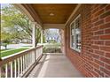 Covered porch featuring classic columns, wood ceiling, brick wall and view of the neighborhood at 4777 Madras Ct, Zionsville, IN 46077