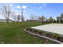 Expansive backyard featuring a concrete patio and lush green lawn, perfect for outdoor gatherings at 4831 E Oak Hill E Dr, Lebanon, IN 46052