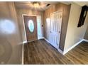 Inviting entryway with wood-look floors, decorative front door, and a convenient coat closet at 52 Spring Lake Ct, Trafalgar, IN 46181
