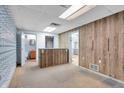 Spacious room with wood paneling and access to additional rooms, offering versatile use at 5301 Old Smith Valley Rd, Greenwood, IN 46143