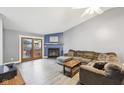 Comfortable living room with a fireplace, plush sofa, and backyard access at 5431 Carlton Ct, Indianapolis, IN 46224