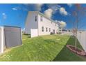 Spacious fenced backyard with a patio, green lawn, and storage shed at 5839 Altar Bell Cir, Greenwood, IN 46143