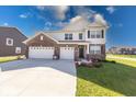 Handsome two-story home featuring brick and siding, along with a well-kept lawn at 5839 Altar Bell Cir, Greenwood, IN 46143