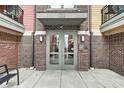 The entrance to 622 showcases brick walls and a glass door with a gray canopy at 622 E 10Th St # 303, Indianapolis, IN 46202