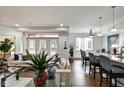 Bright living room with hardwood floors, white sofa, and view of kitchen and dining areas at 622 E 10Th St # 303, Indianapolis, IN 46202