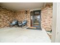 Charming front porch with rocking chairs and a welcome mat, leading to the front door at 632 Ridgeview Ln, Columbus, IN 47201