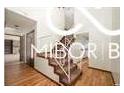 Welcoming entryway showcasing a staircase, hardwood floors, and ample natural light, creating a warm atmosphere at 8500 N Ravenwood Dr, Muncie, IN 47303